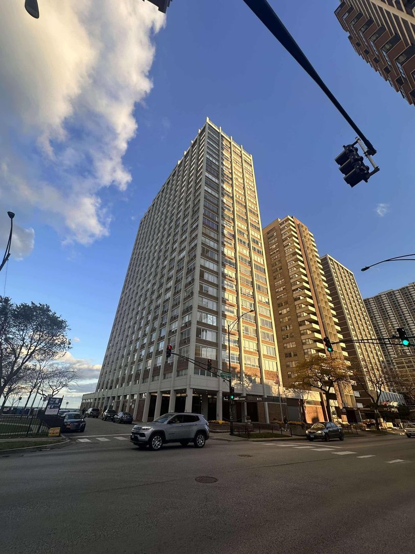 a view of a tall building next to a road