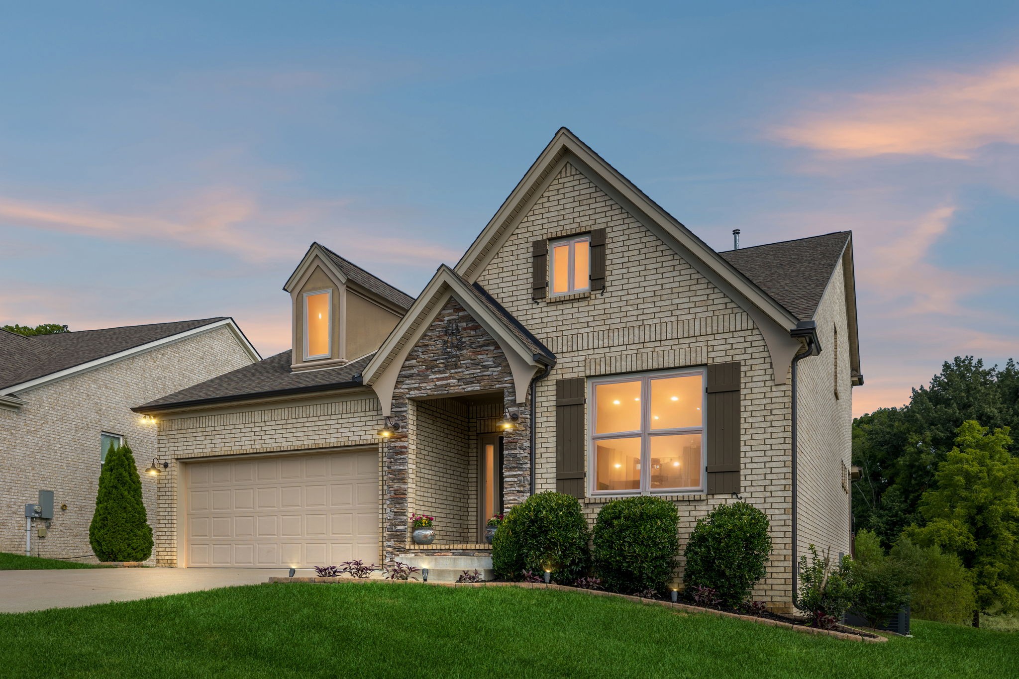 a front view of a house with a yard and garage