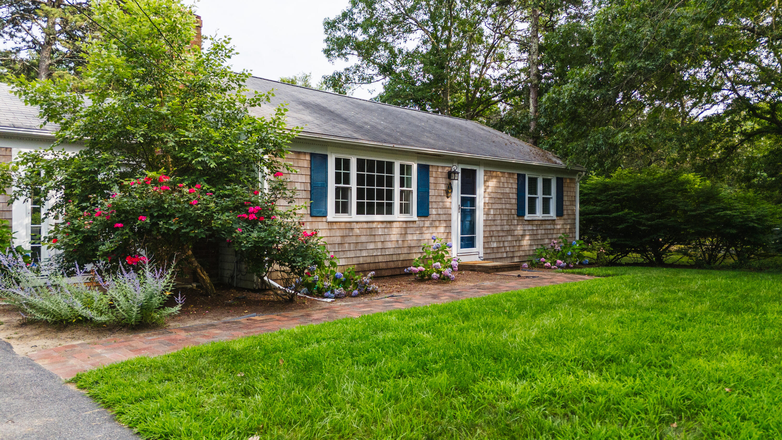 a view of a house with a yard and a garden