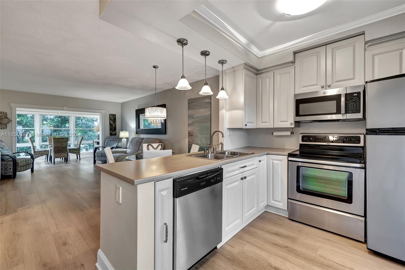 a kitchen with a sink stove and microwave