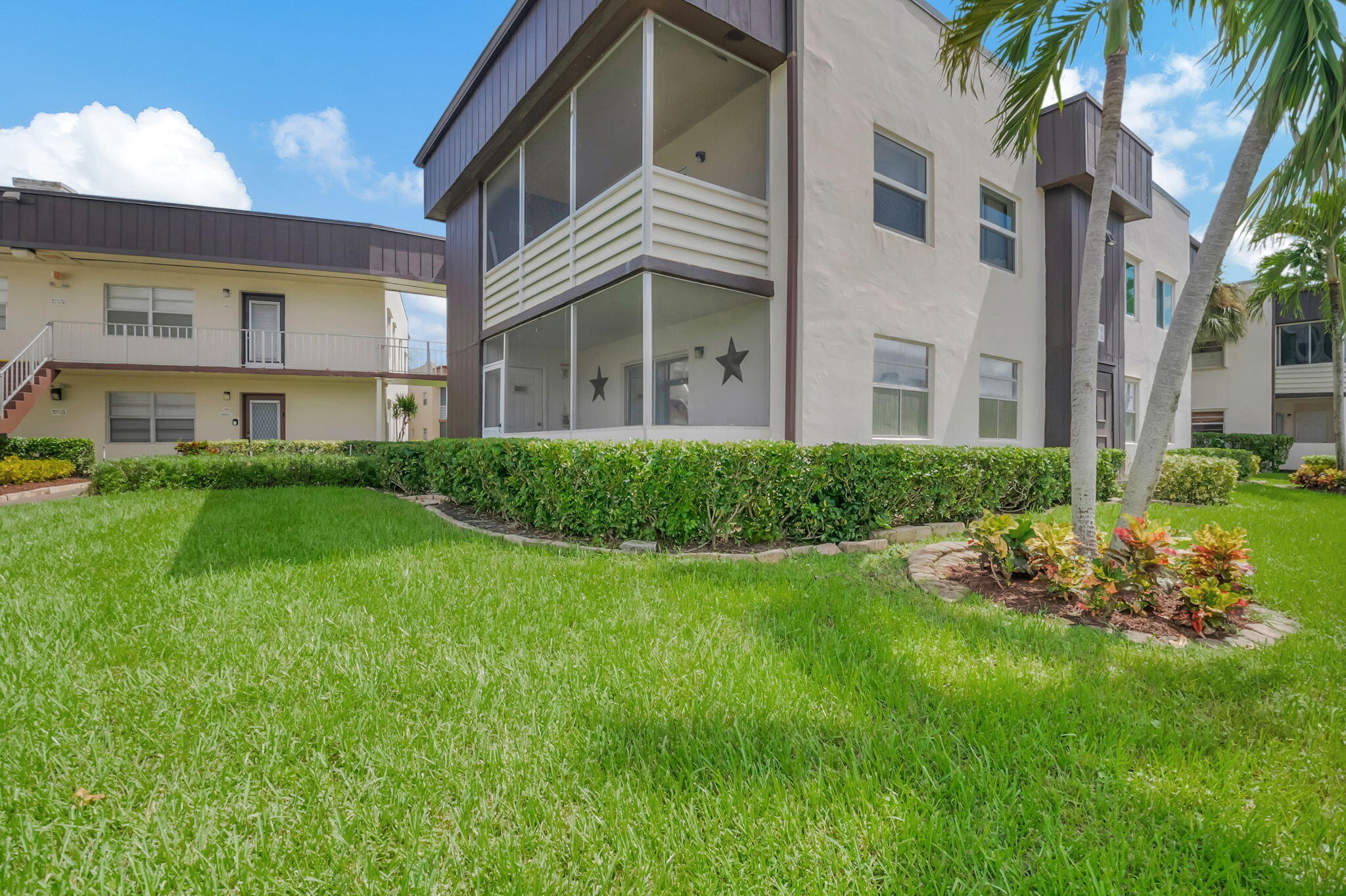 a view of backyard of house with green space