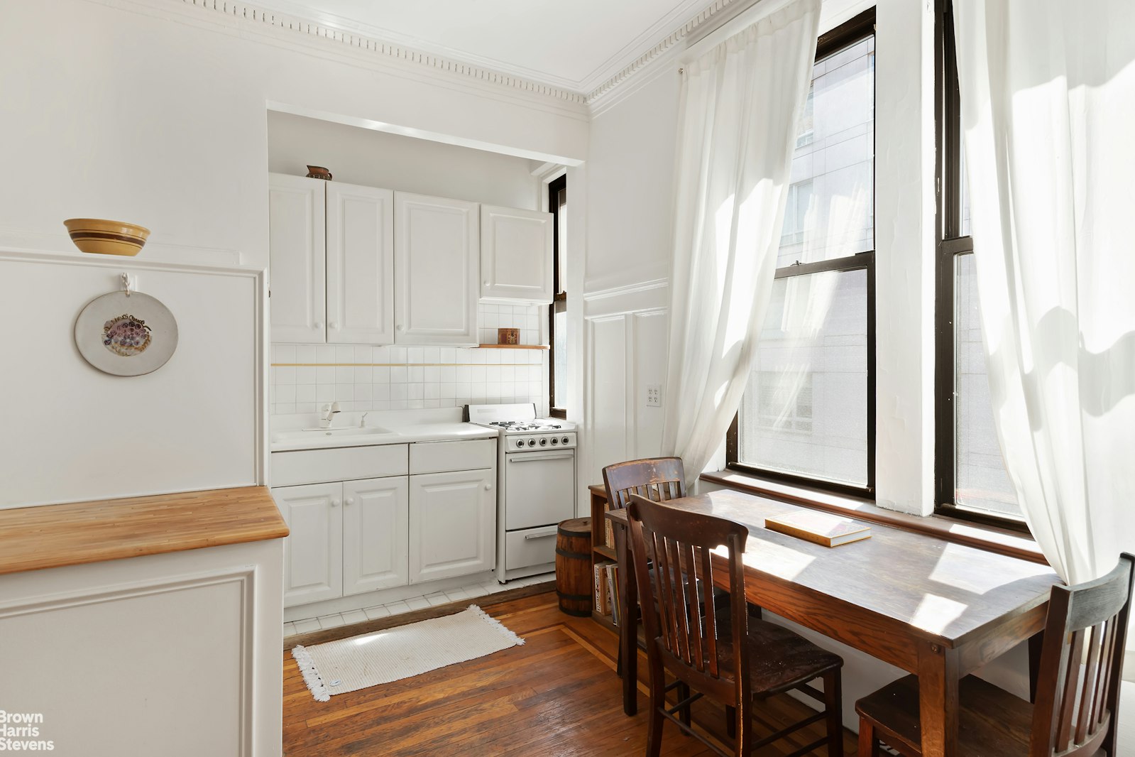 a room with a table chairs and a refrigerator