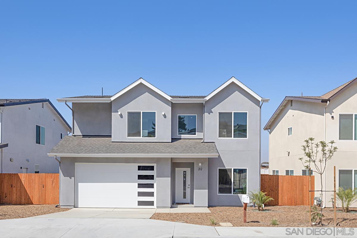 a view of a house with a yard and garage