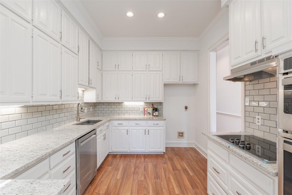 a kitchen with granite countertop white cabinets and white appliances