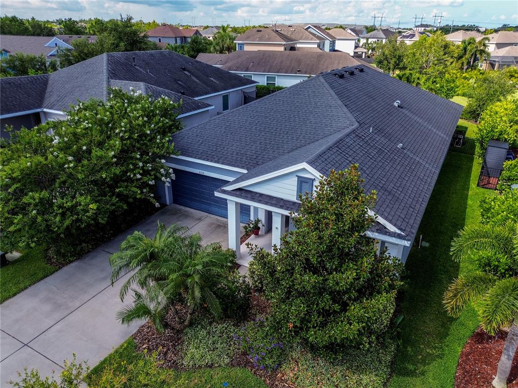 an aerial view of house with yard and outdoor seating