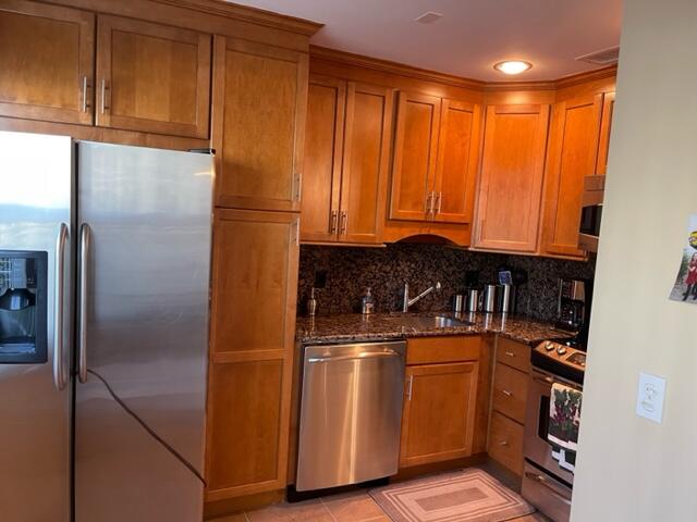 a kitchen with stainless steel appliances granite countertop a refrigerator and a sink