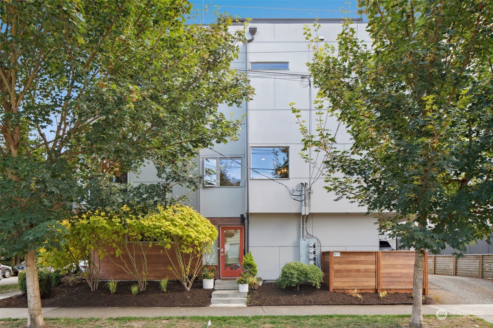 a front view of a house with trees