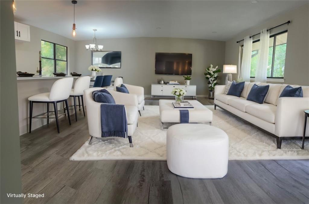 a living room with fireplace furniture and a flat screen tv