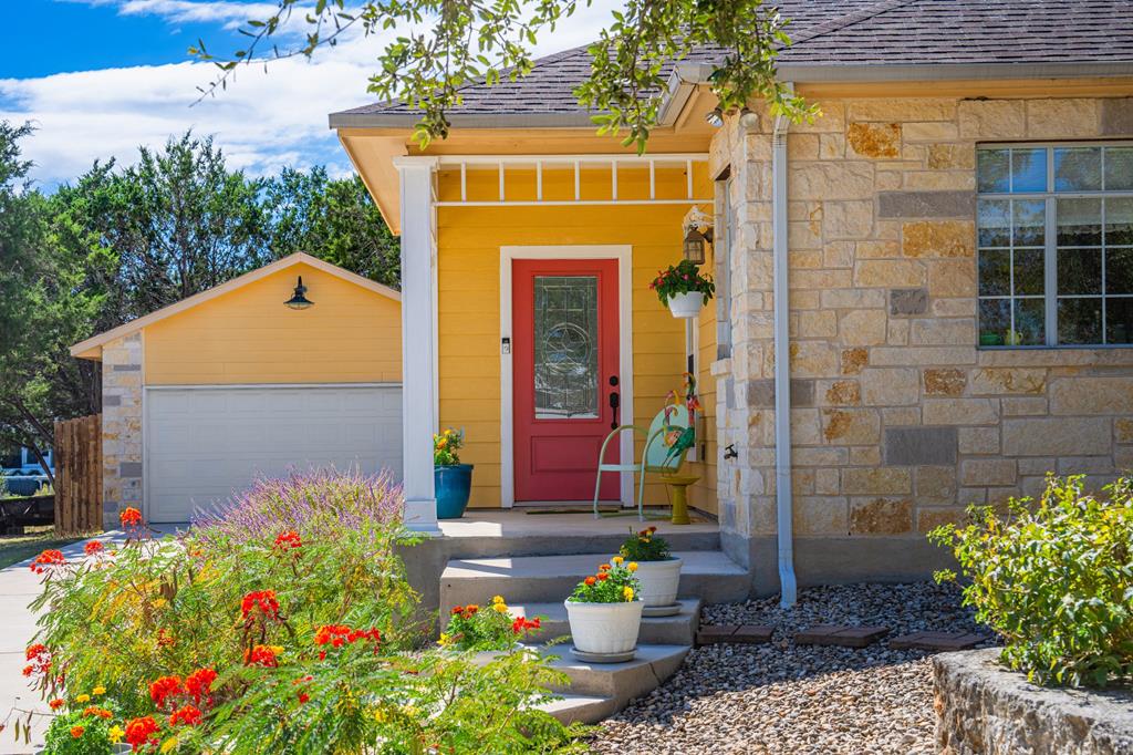 a front view of a house with a garden