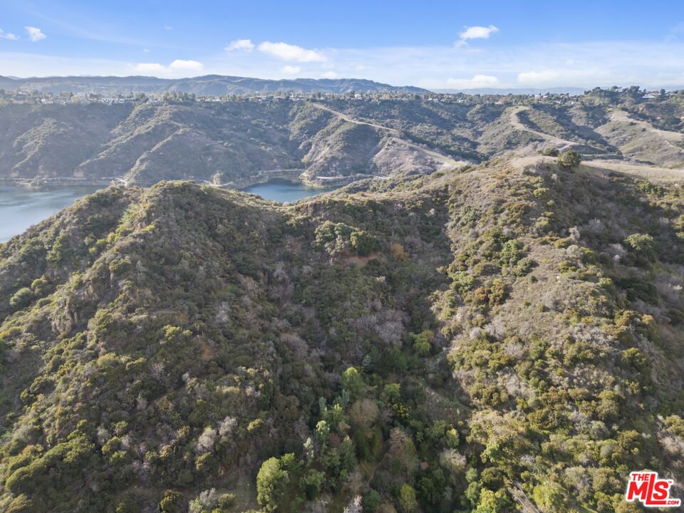 a view of a city of mountains in the background