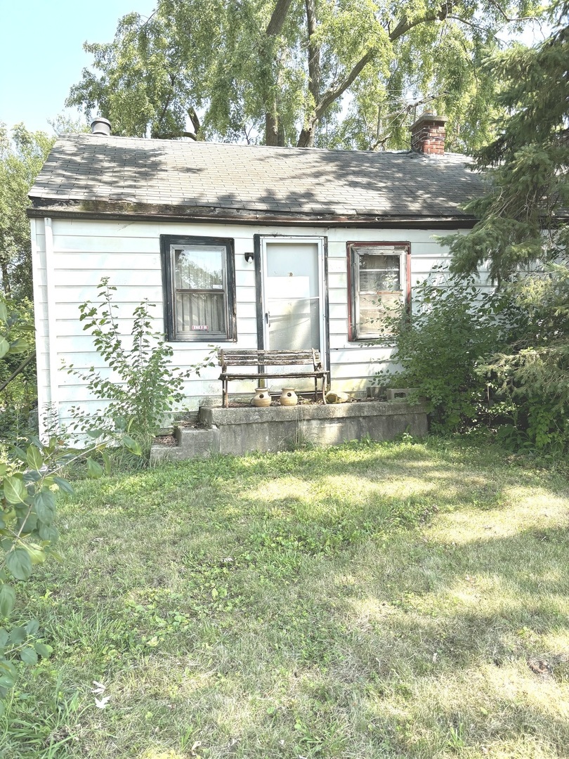 a view of a house with a yard balcony and sitting area