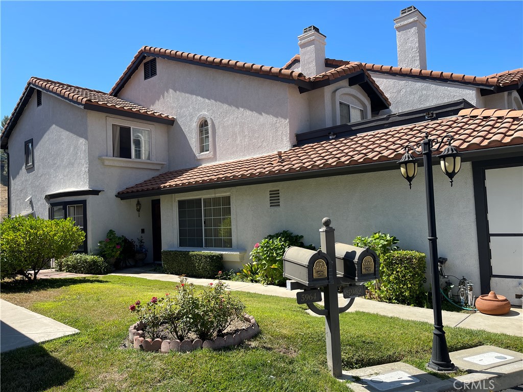 a front view of a house with garden and porch