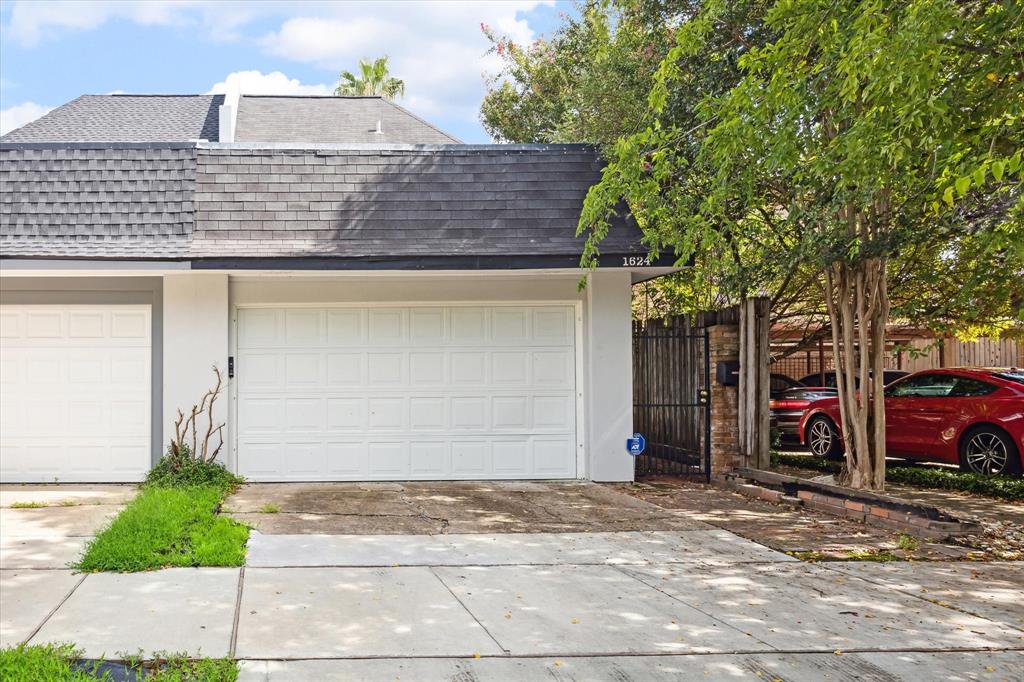 Double attached garage with double driveway. A large deck above the garage.