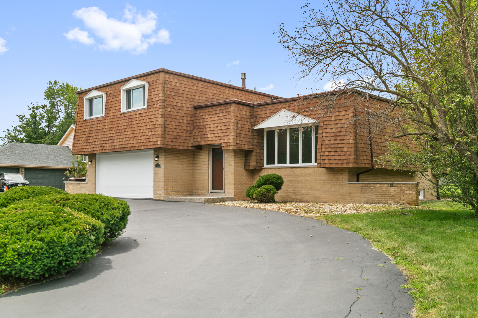 a front view of a house with a yard and garage