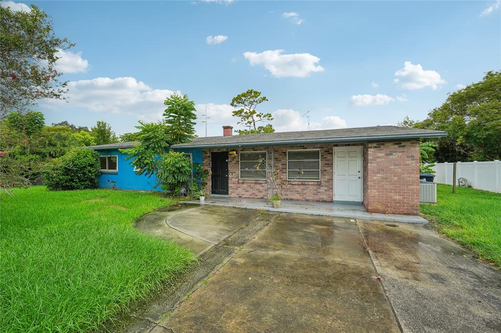 a front view of a house with a garden and plants