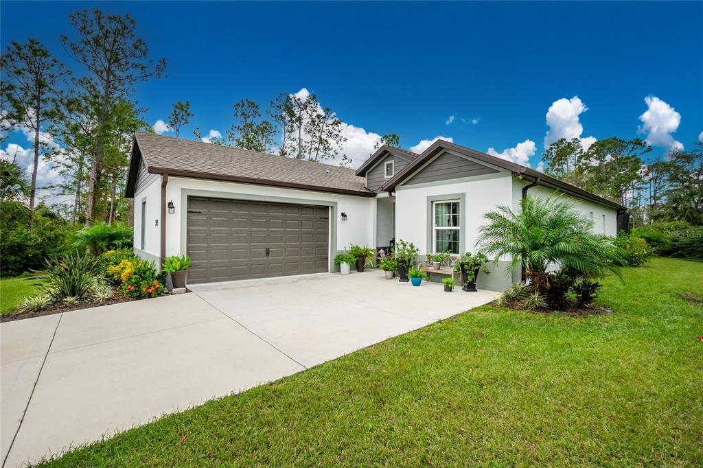 a front view of a house with a yard and a garage