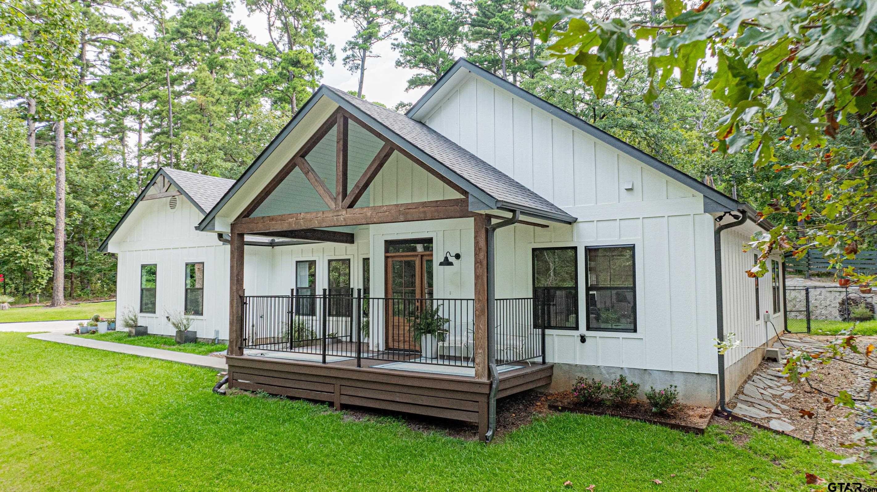 a view of a house with a yard and sitting area