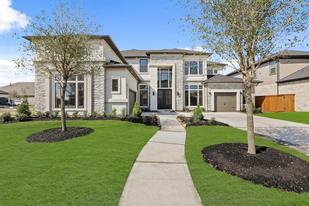 a front view of a house with a garden