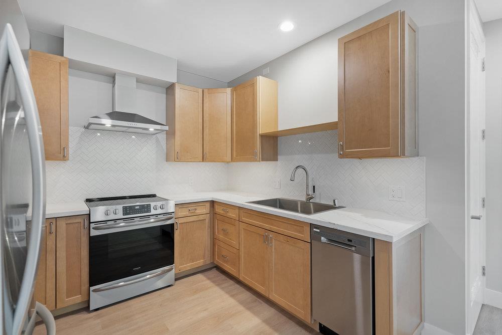 a kitchen with a sink stove and cabinets