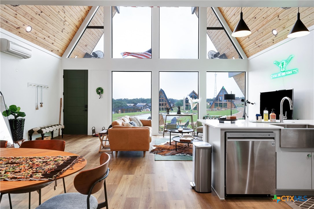 a living room with furniture and floor to ceiling windows