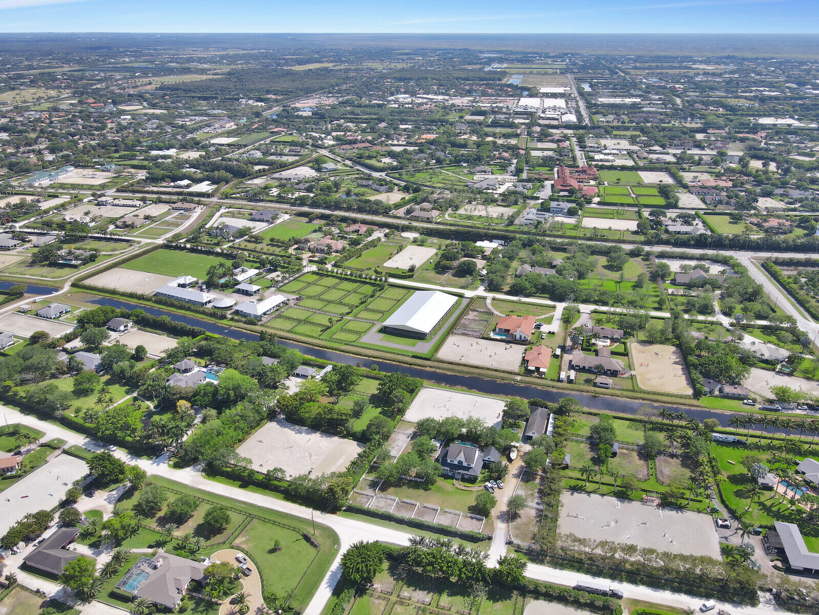 an aerial view of city lake and trees