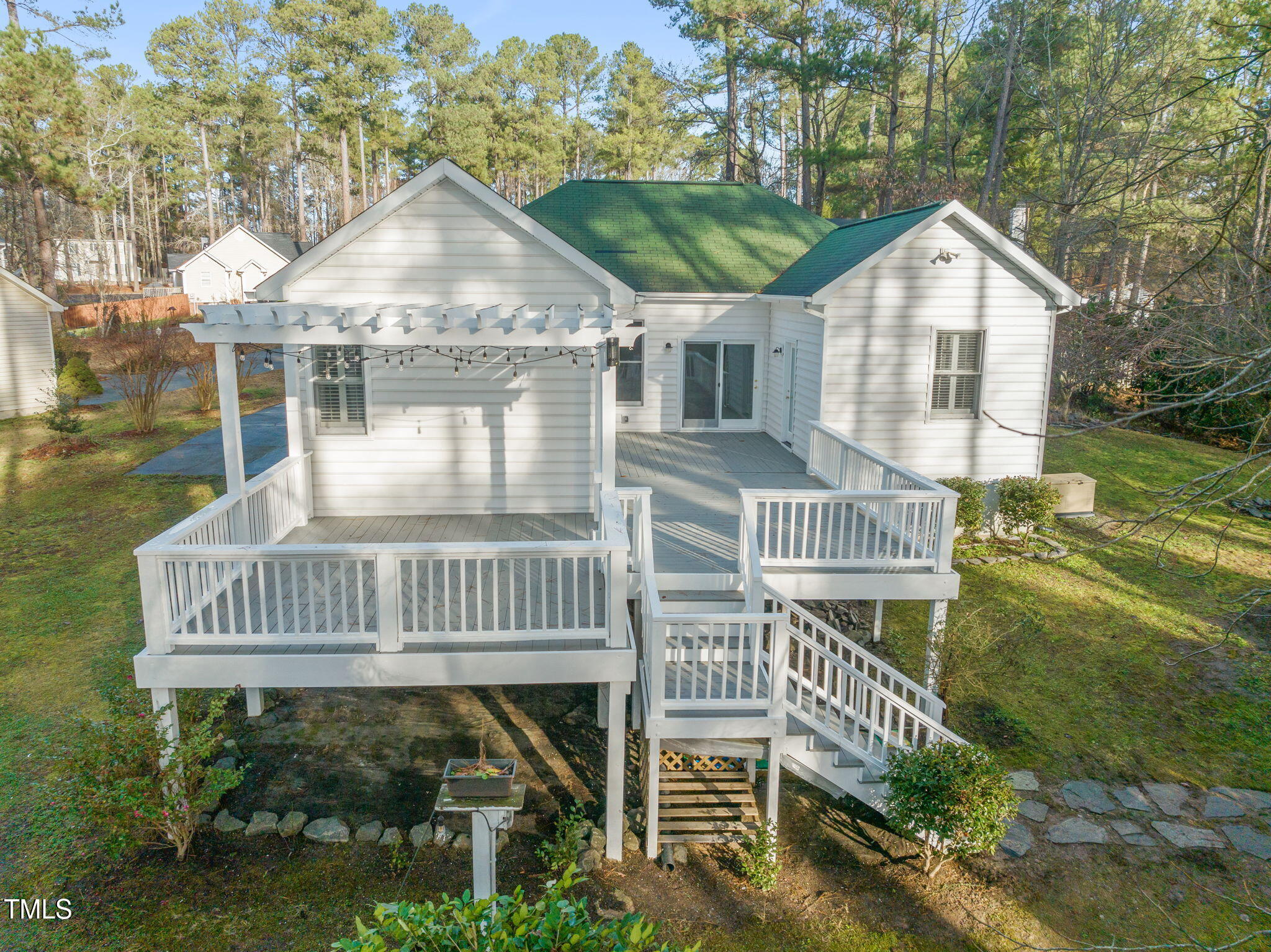 a view of a house with a yard and deck