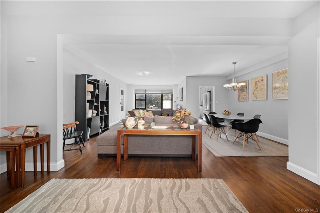 Living room with an inviting chandelier and dark hardwood / wood-style flooring