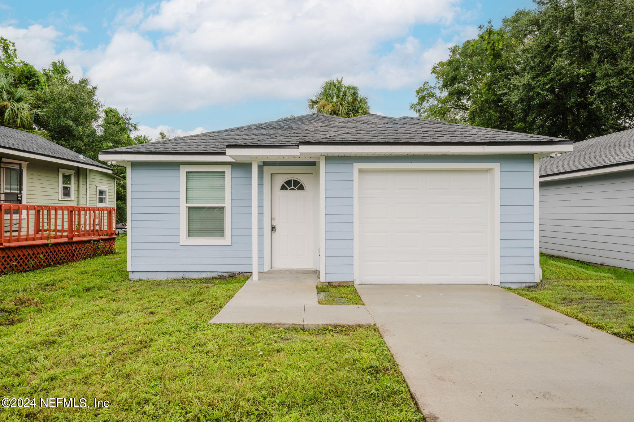 a front view of house with yard and green space