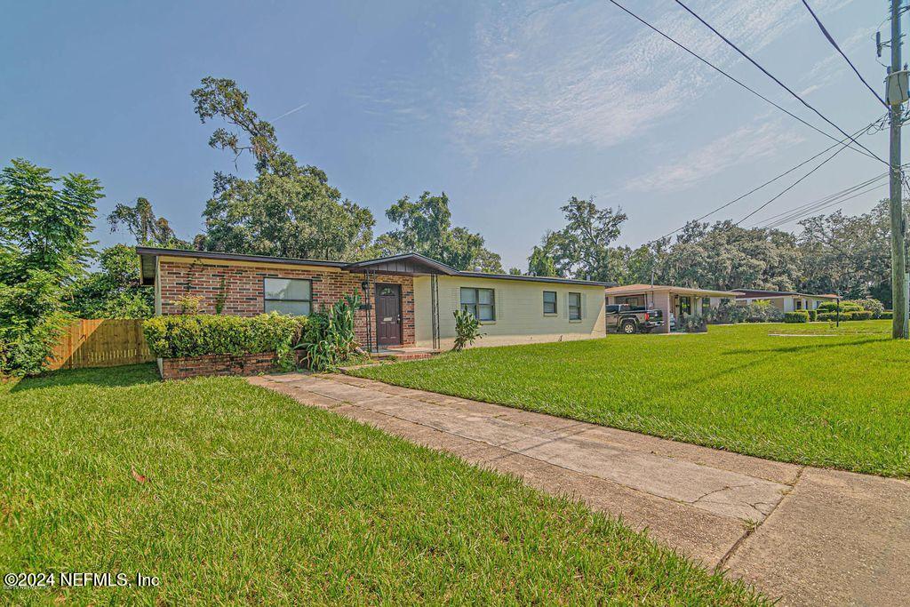 a front view of house with yard and green space