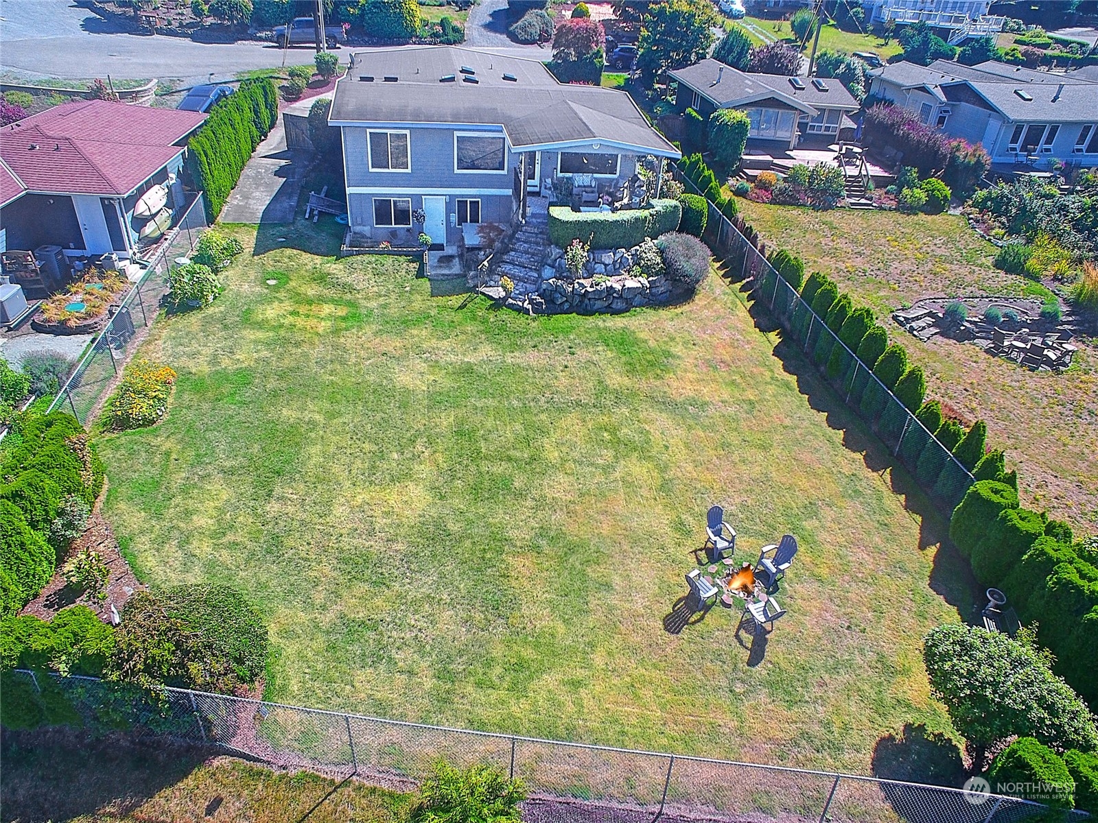 an aerial view of a house with a garden and lake view