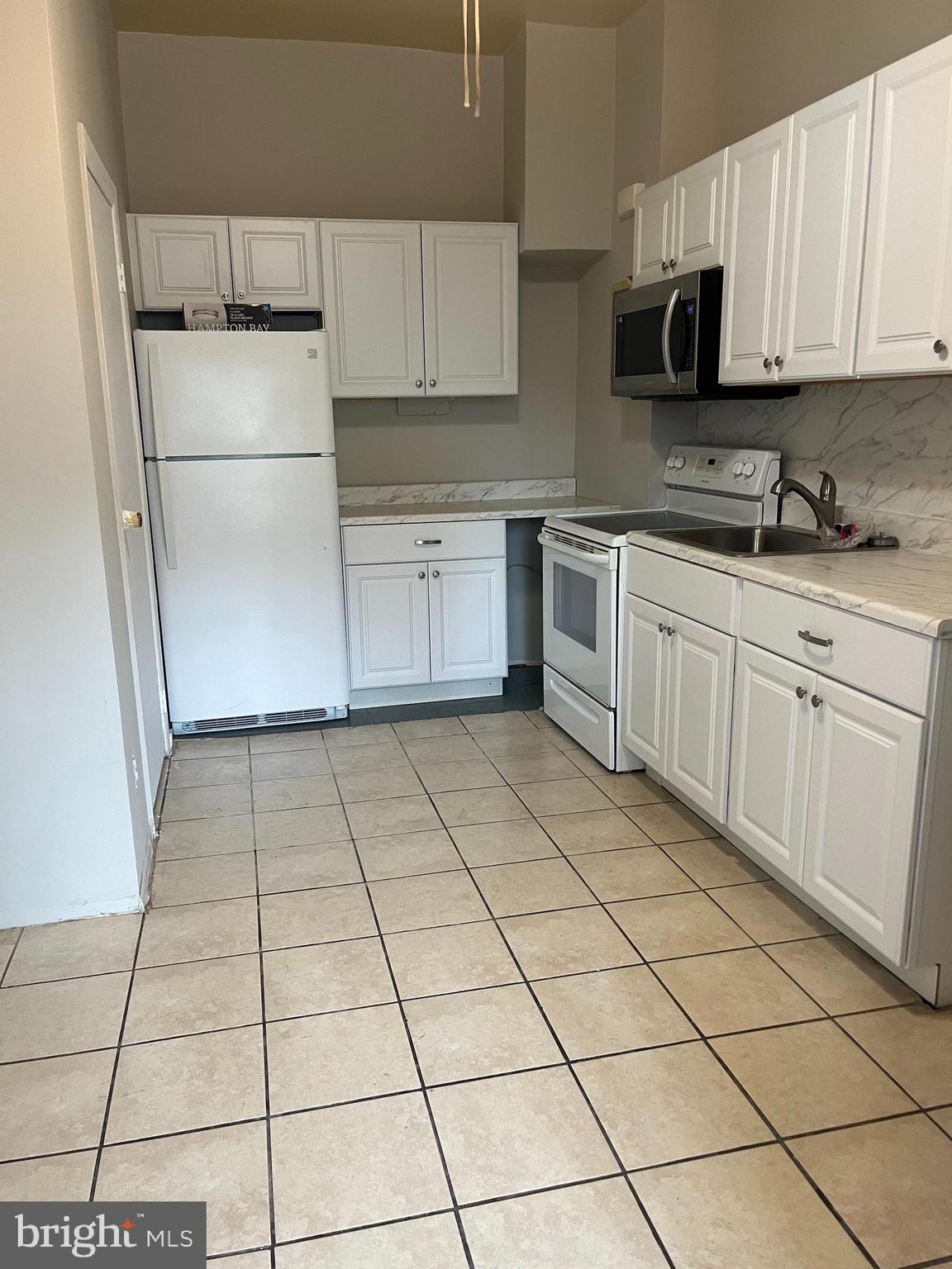 a kitchen with a stove a sink and a refrigerator