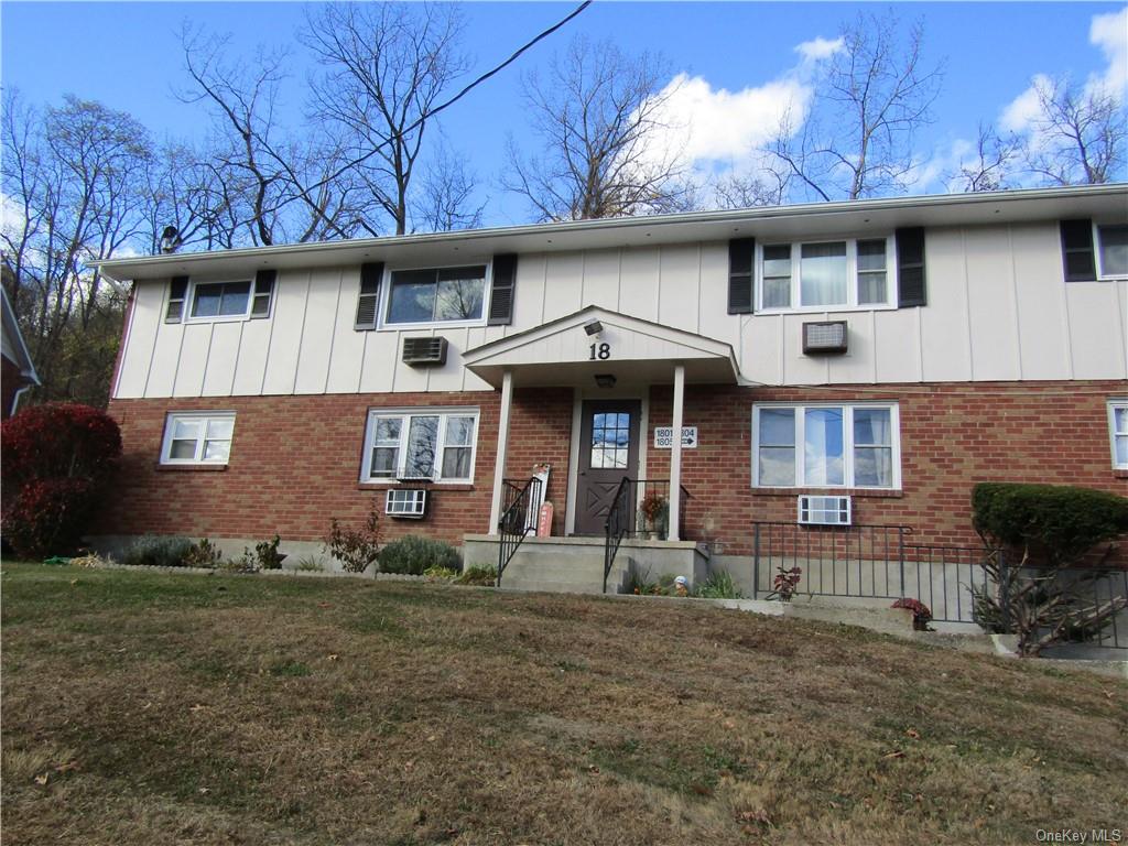 View of front of property with a front lawn and cooling unit