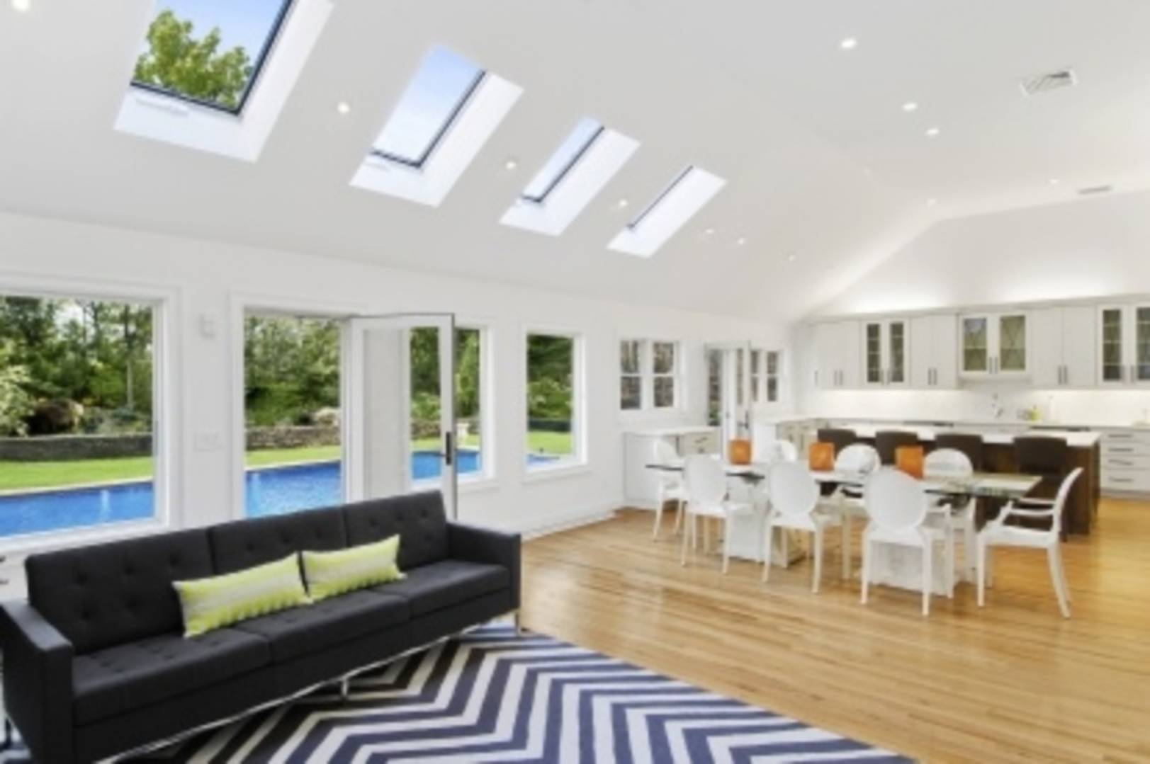 a living room with furniture wooden floor and a large window