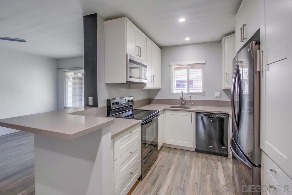 a kitchen with a sink stove and refrigerator