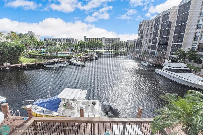 a view of roof deck with outdoor seating and lake