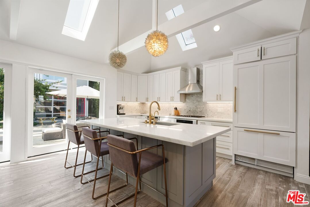 a kitchen with a table chairs and a refrigerator