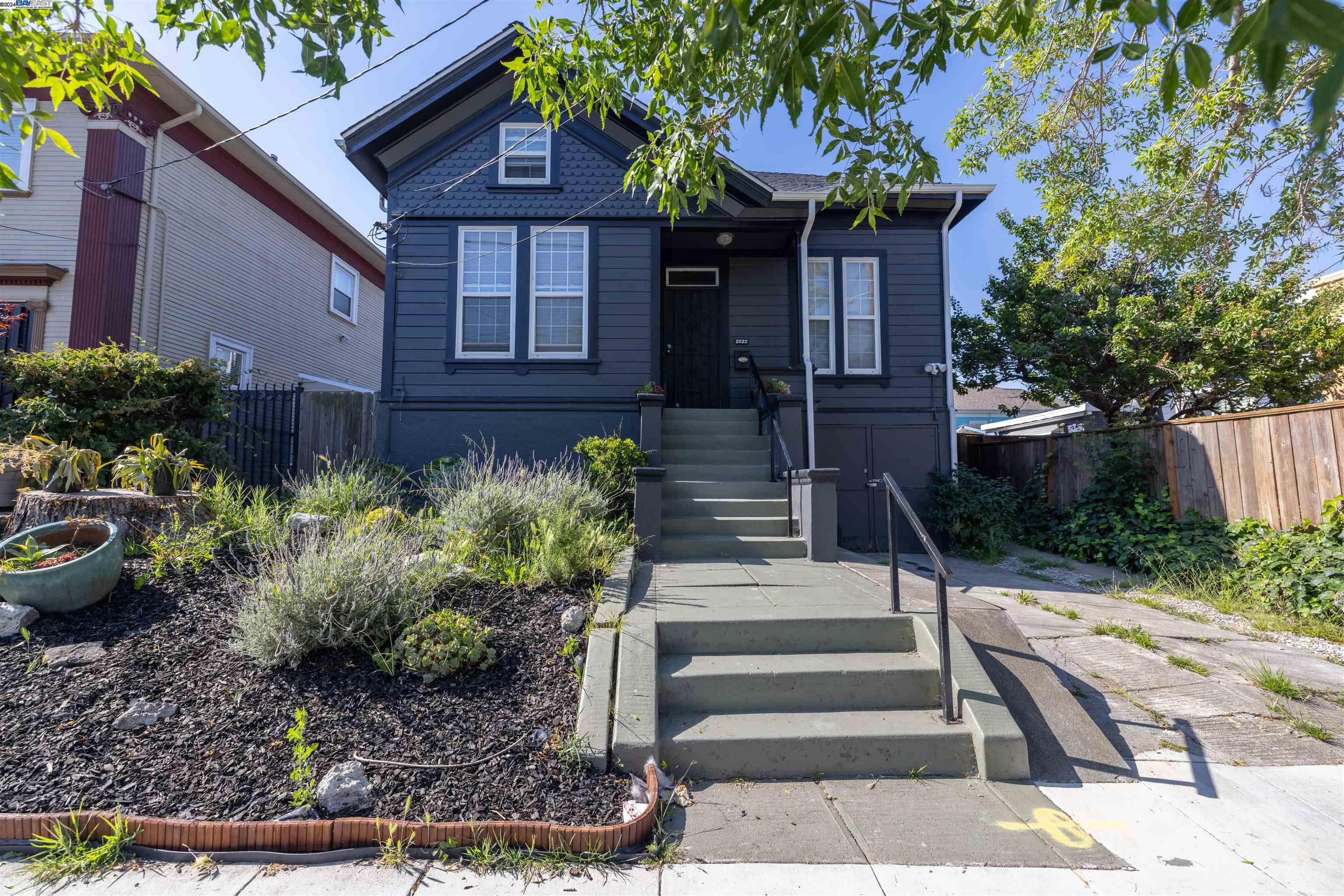 a front view of a house with a yard garage and outdoor seating