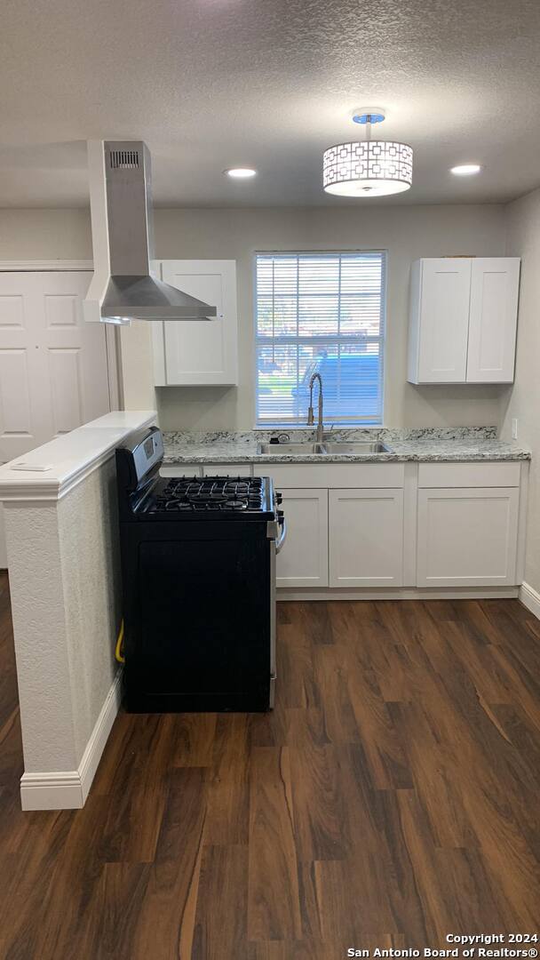 a kitchen with stainless steel appliances granite countertop a stove and a refrigerator