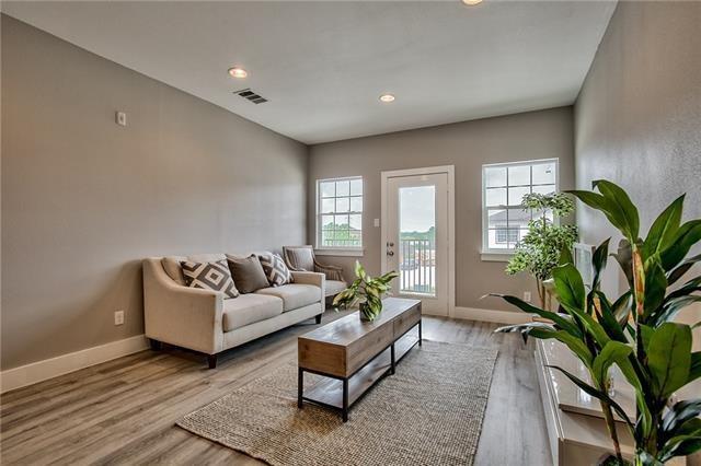 a living room with furniture mirror and a potted plant