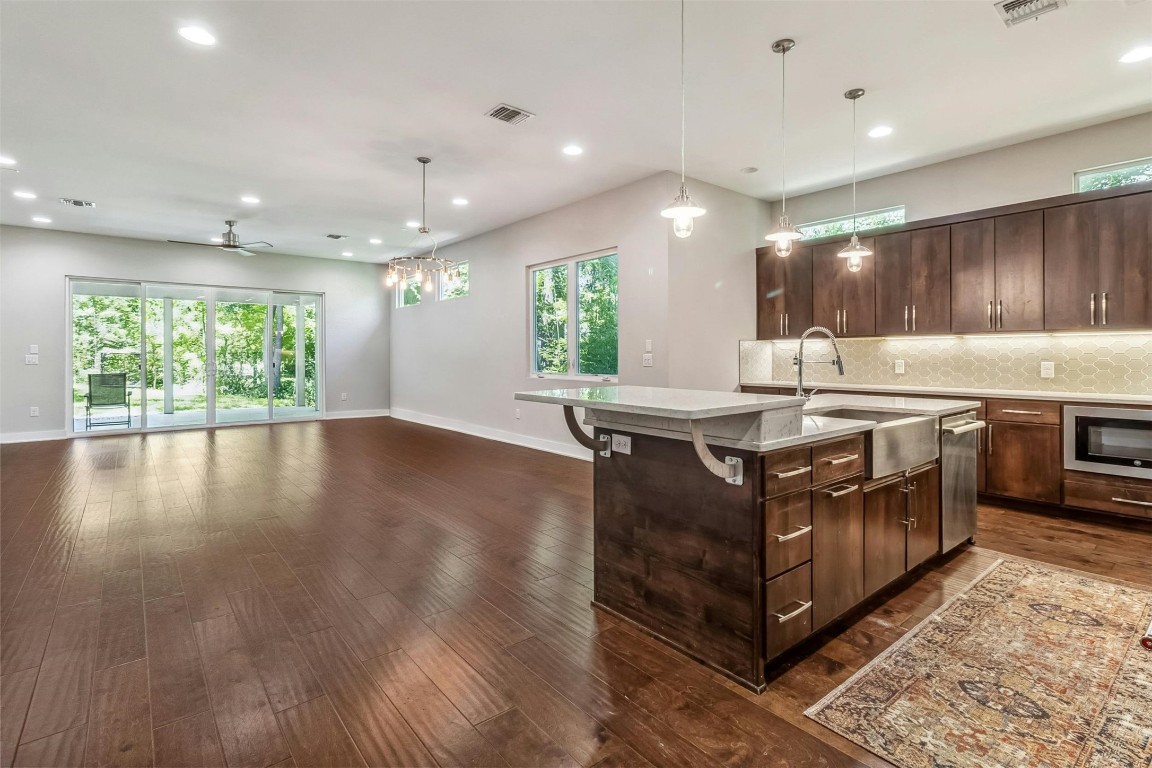 a kitchen with stainless steel appliances granite countertop a stove a sink and a refrigerator