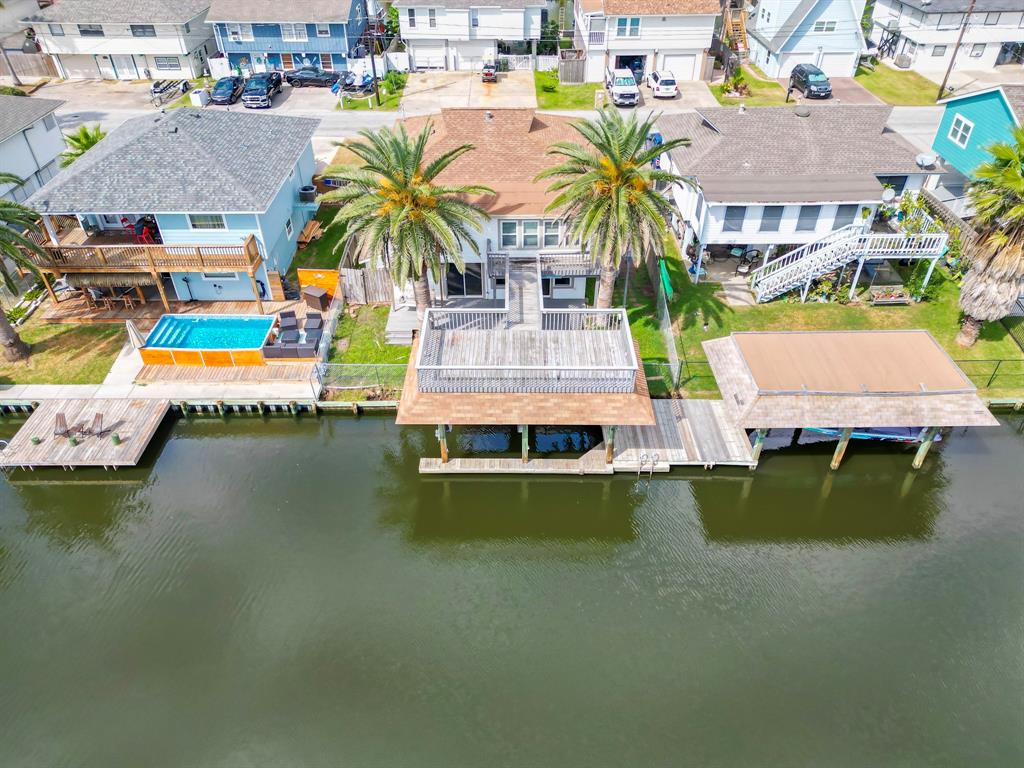 an aerial view of residential houses with outdoor space and swimming pool