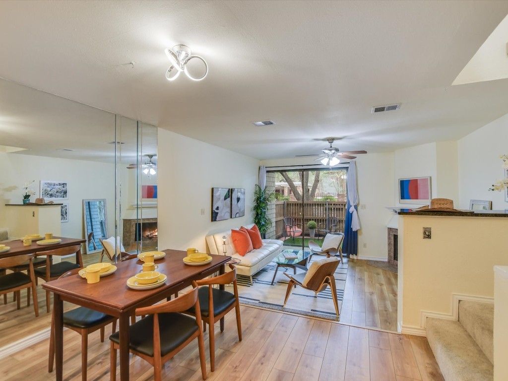 OPEN Dining room with living and patio and pool beyond.