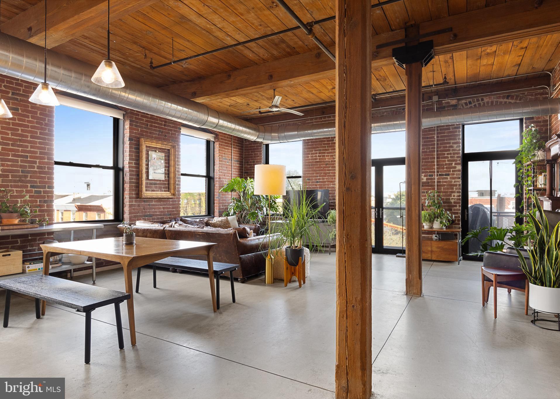 a view of a livingroom with furniture and floor to ceiling window