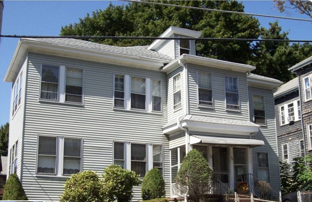 a front view of a house with plants