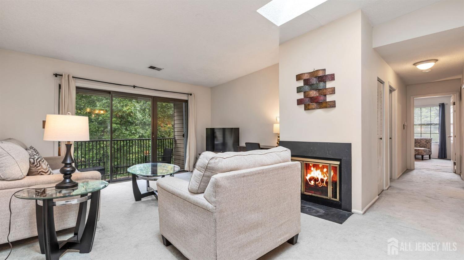 a view of a livingroom with furniture and a flat screen tv