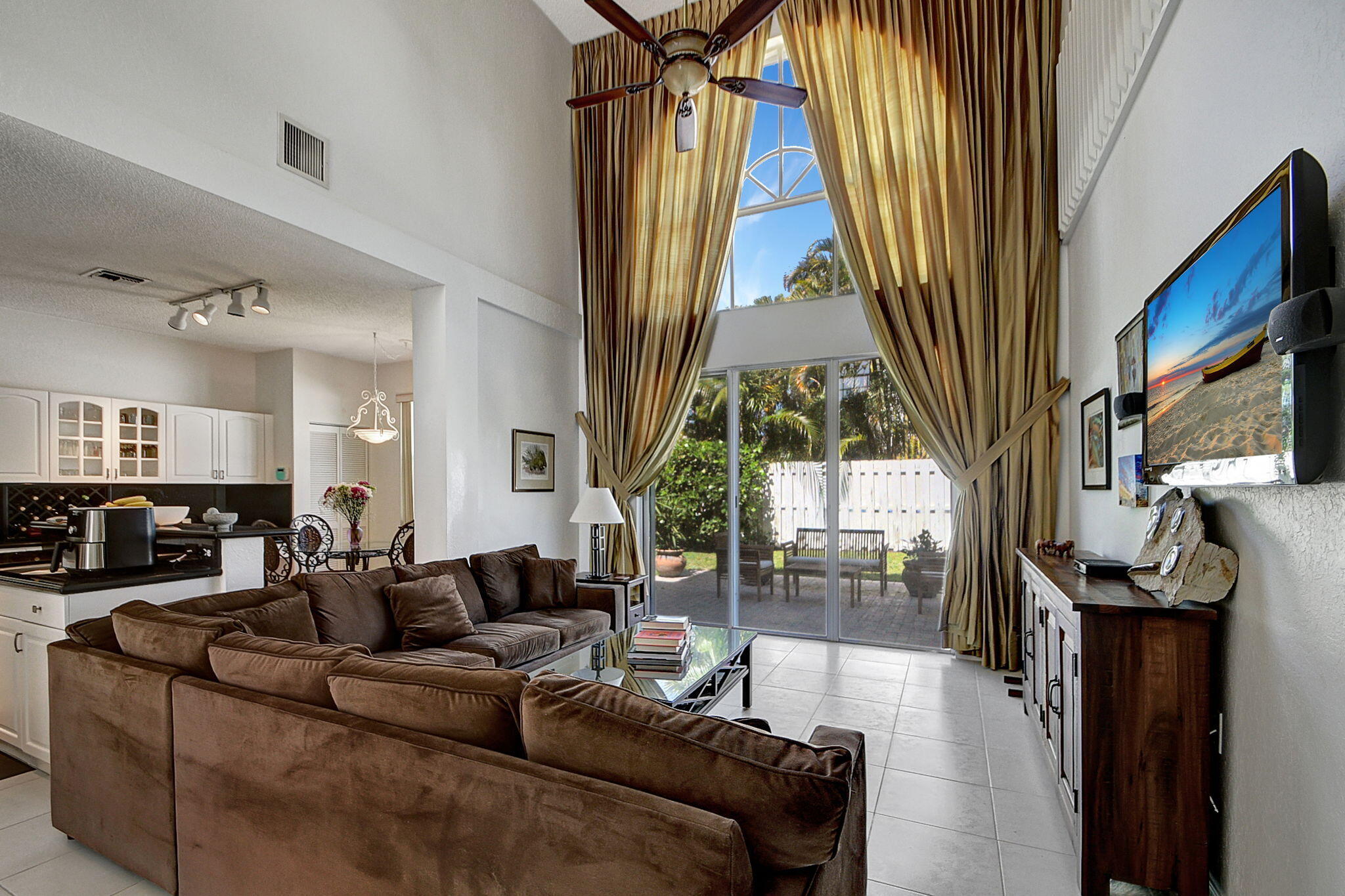 a living room with furniture a fireplace and a large window