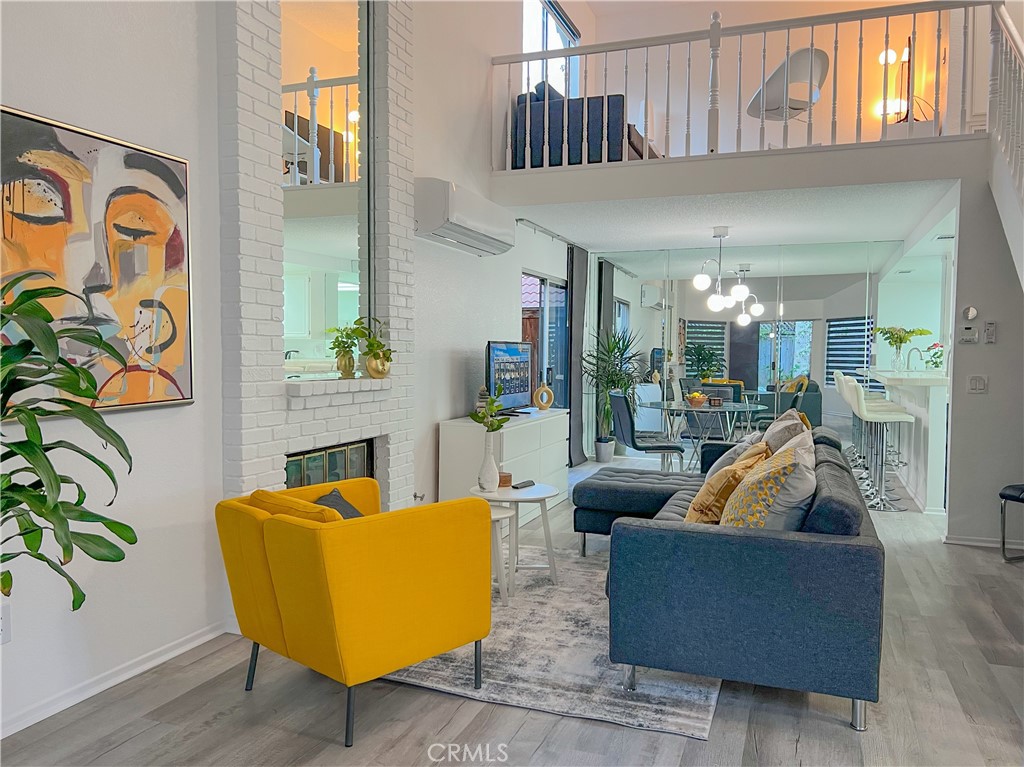 a living room with fireplace furniture and a potted plant