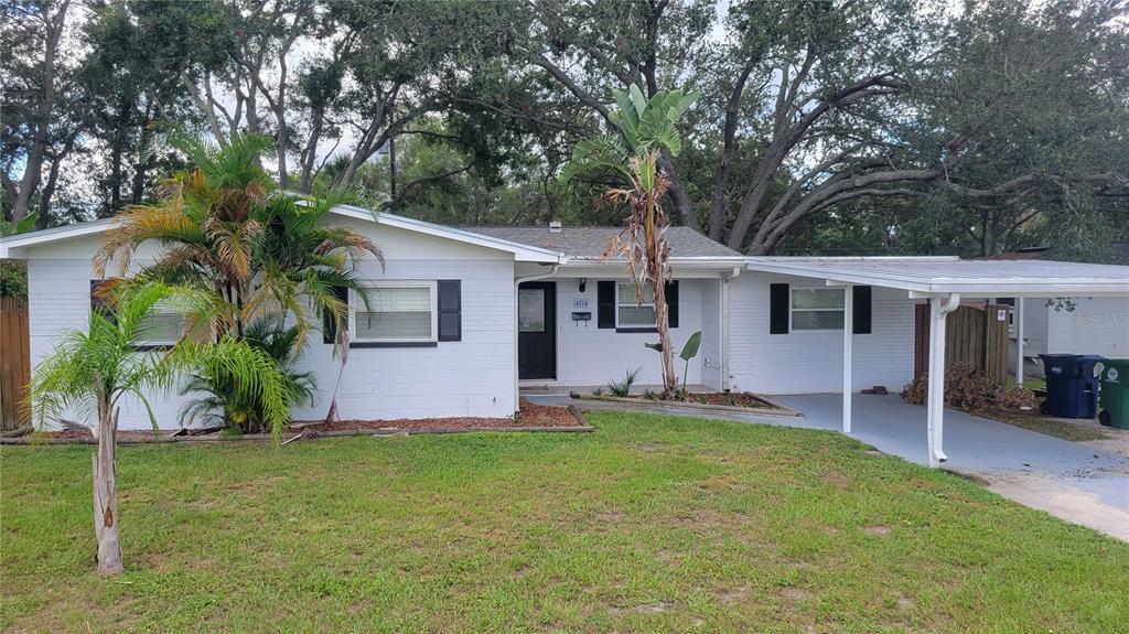 a front view of house with a garden and patio