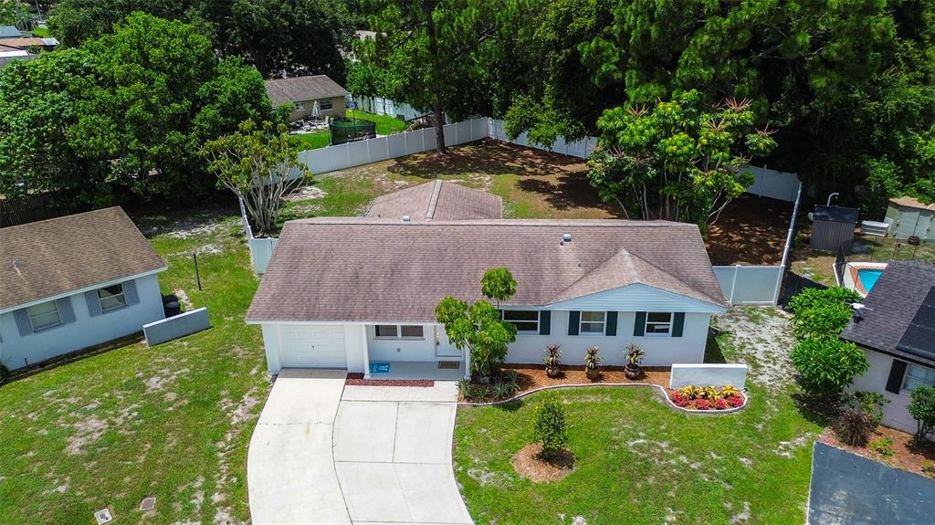 an aerial view of a house with swimming pool garden and patio