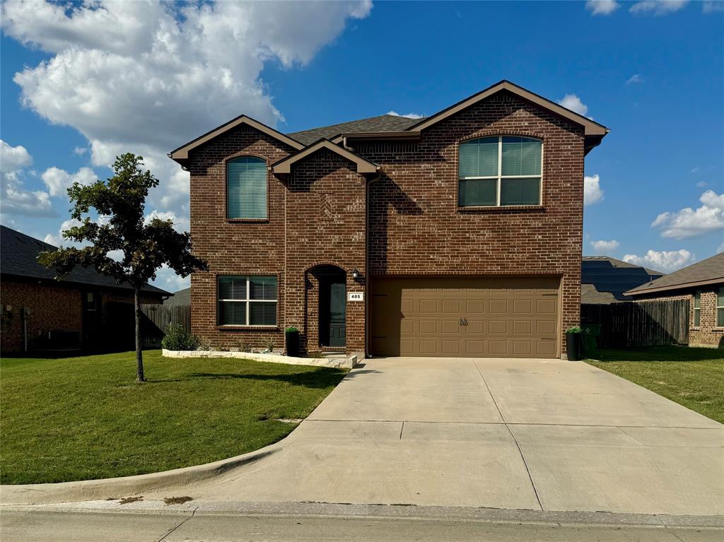 a front view of a house with a yard